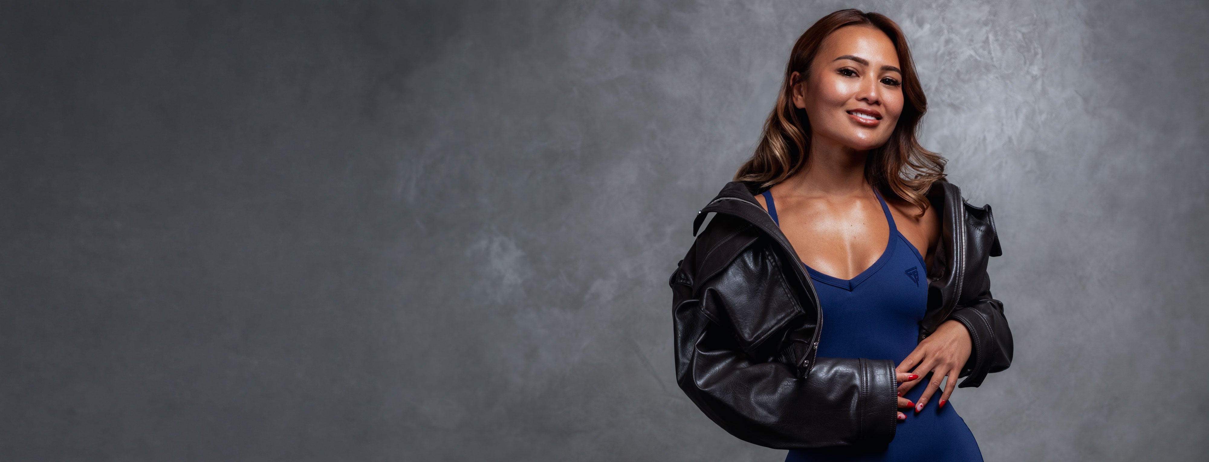 Founder wearing activewear standing in gym environment