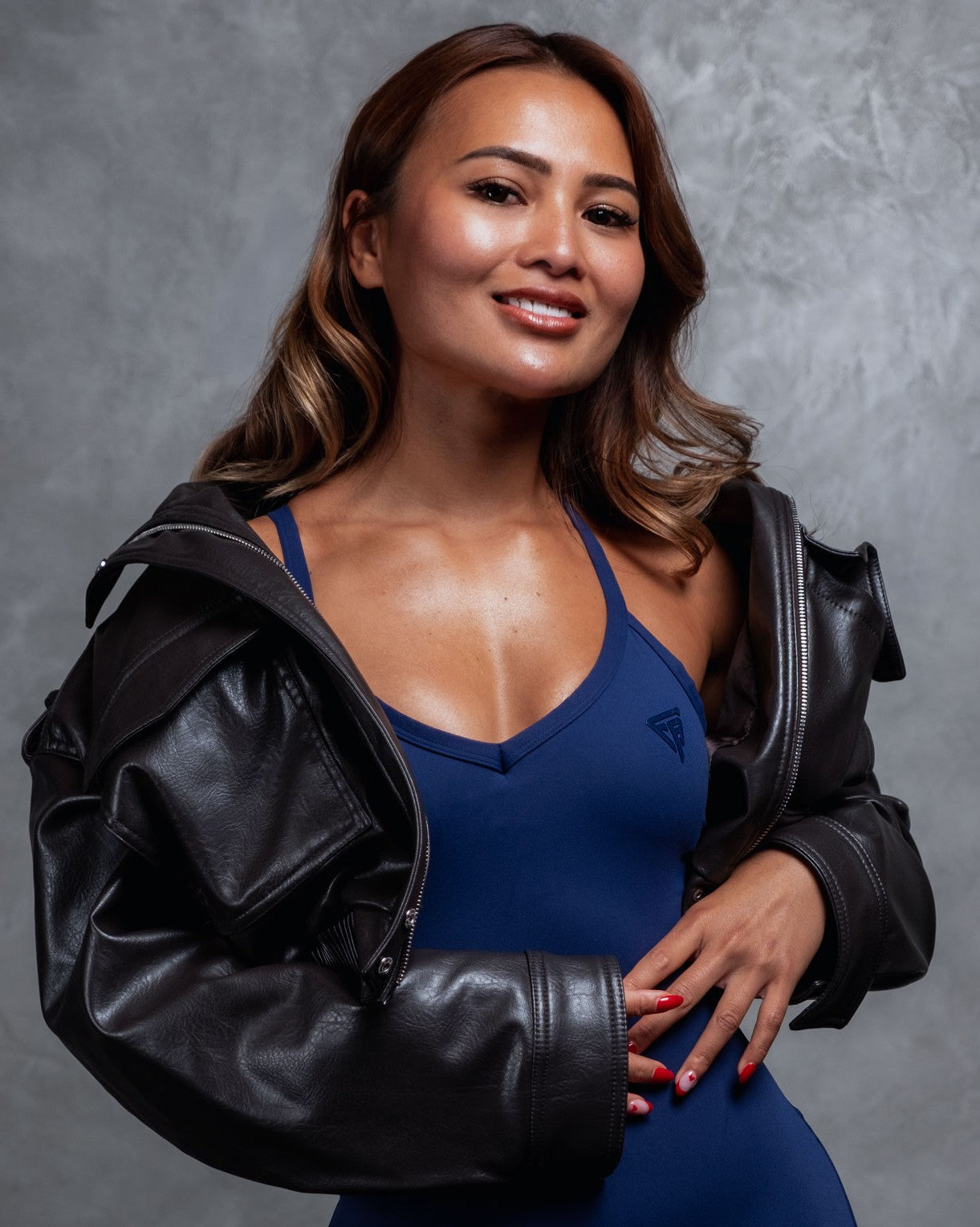 Founder wearing activewear standing in gym environment